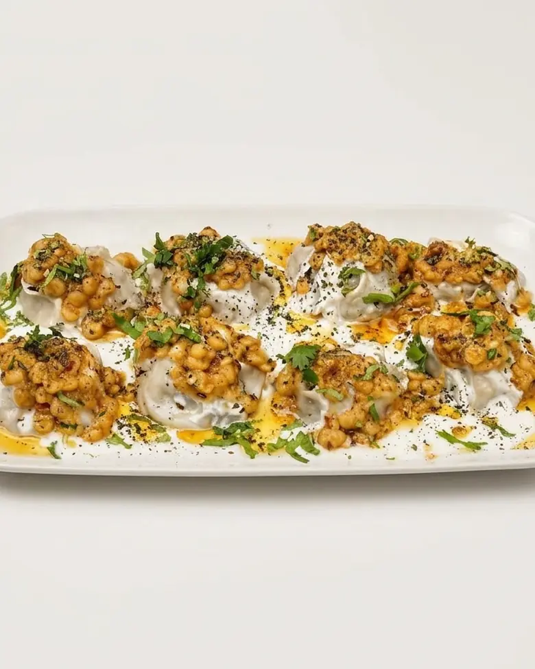 Mantu, Afghan steamed dumplings with garlic yoghurt and split-pea tomato sauce