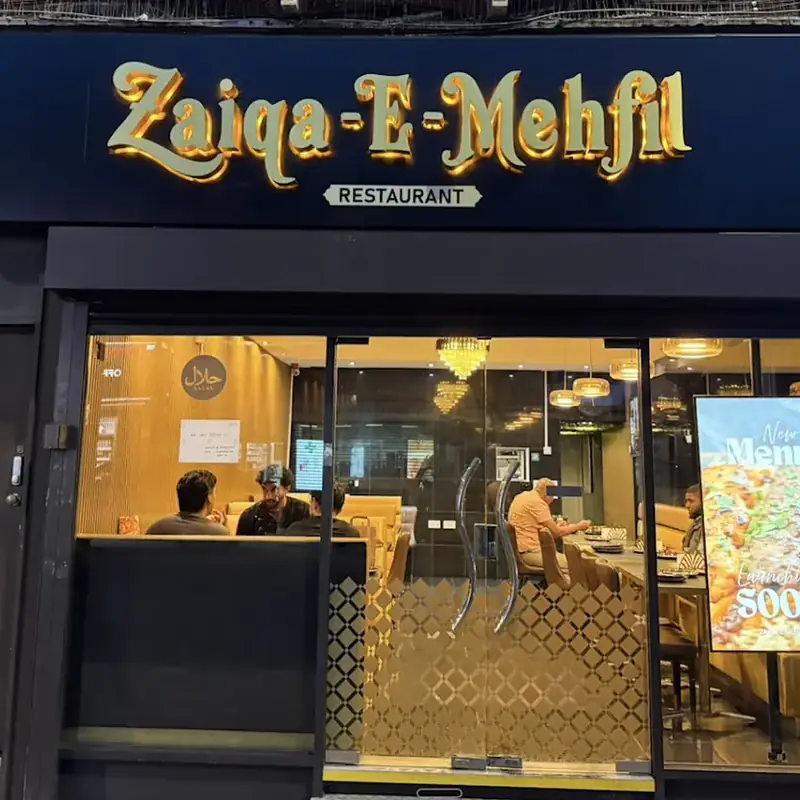 The golden Zaiqa-E-Mehfil sign above the restaurant on Greenford Road