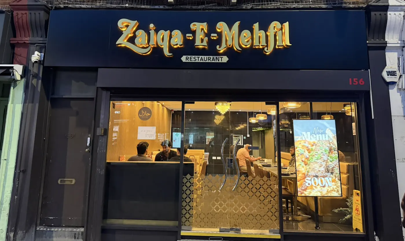 The Zaiqa-E-Mehfil shopfront on Greenford Road, Sudbury Hill, lit up in the evening